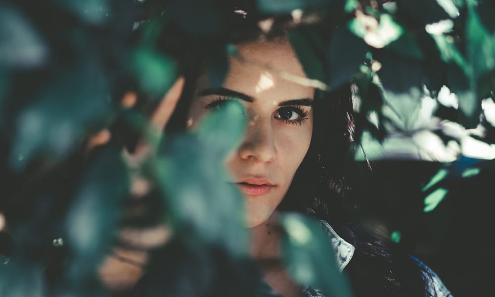 Woman Behind Leaves A L L E F V I N I C I U S 296197 Unsplash